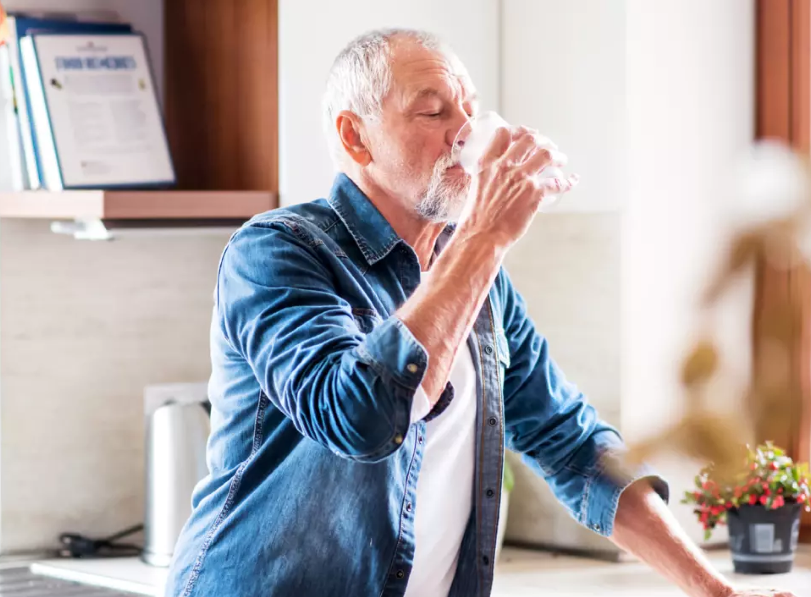 Middle aged man drinking a glass of water